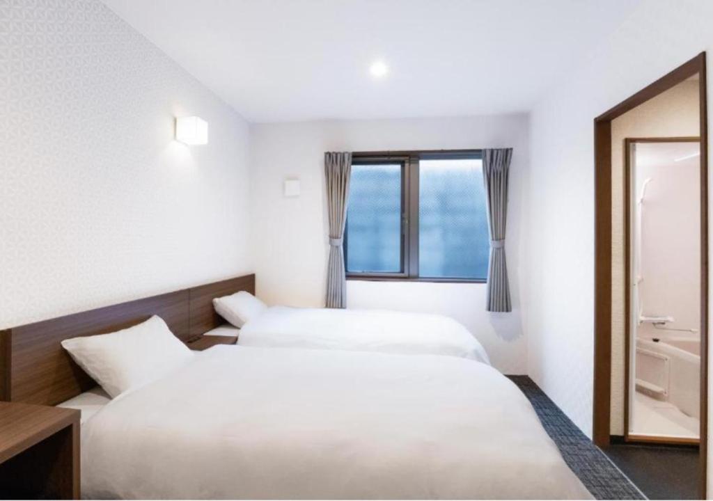 Postel nebo postele na pokoji v ubytování HOTEL DORIA