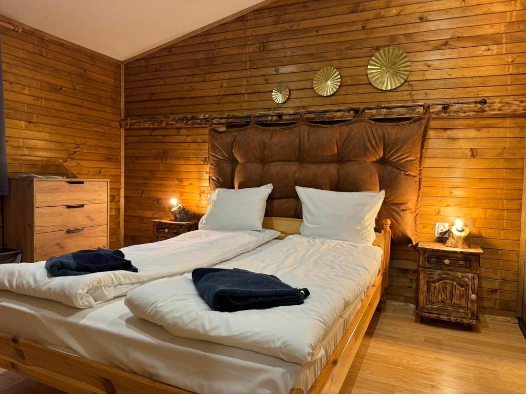 a bedroom with a large bed with two pillows on it at Chalet Iskar Borovets in Borovets