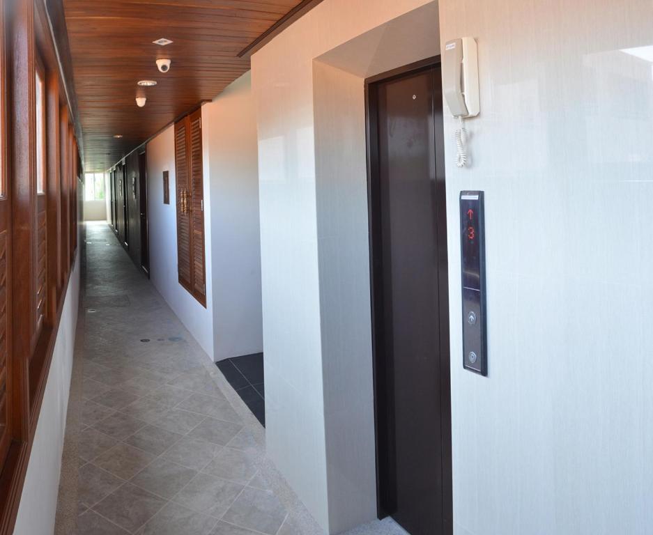 an empty hallway with a door and a walk way at David Residence in Nai Yang Beach