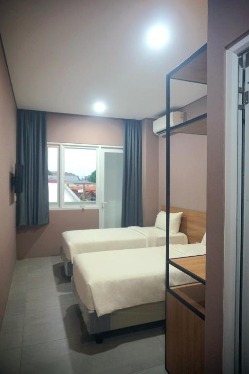 Letto o letti in una camera di VNC Alam Sutera Hotel Powered by Archipelago