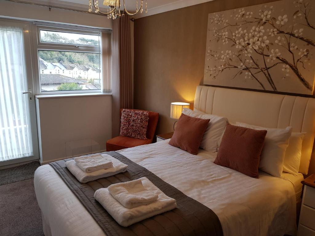 a bedroom with a large bed with two towels on it at Barclay Court Guest House in Torquay