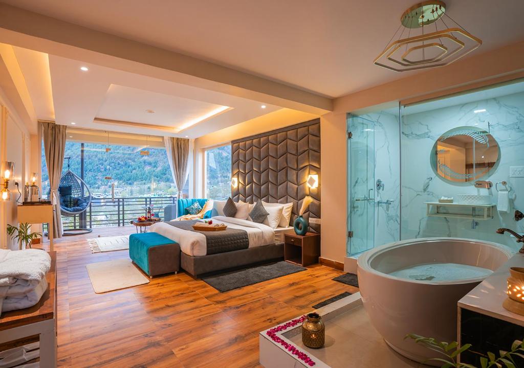 a large bathroom with a bed and a bath tub at Moustache Manali in Manāli
