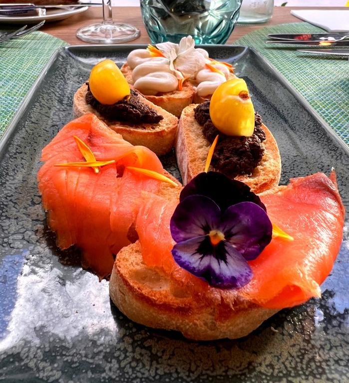 a tray of food with sushi on a table at HOVIMA Suites Costa Adeje in Adeje