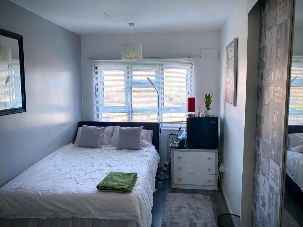 a small bedroom with a bed and a window at Room in apartment home-Stretford in Manchester