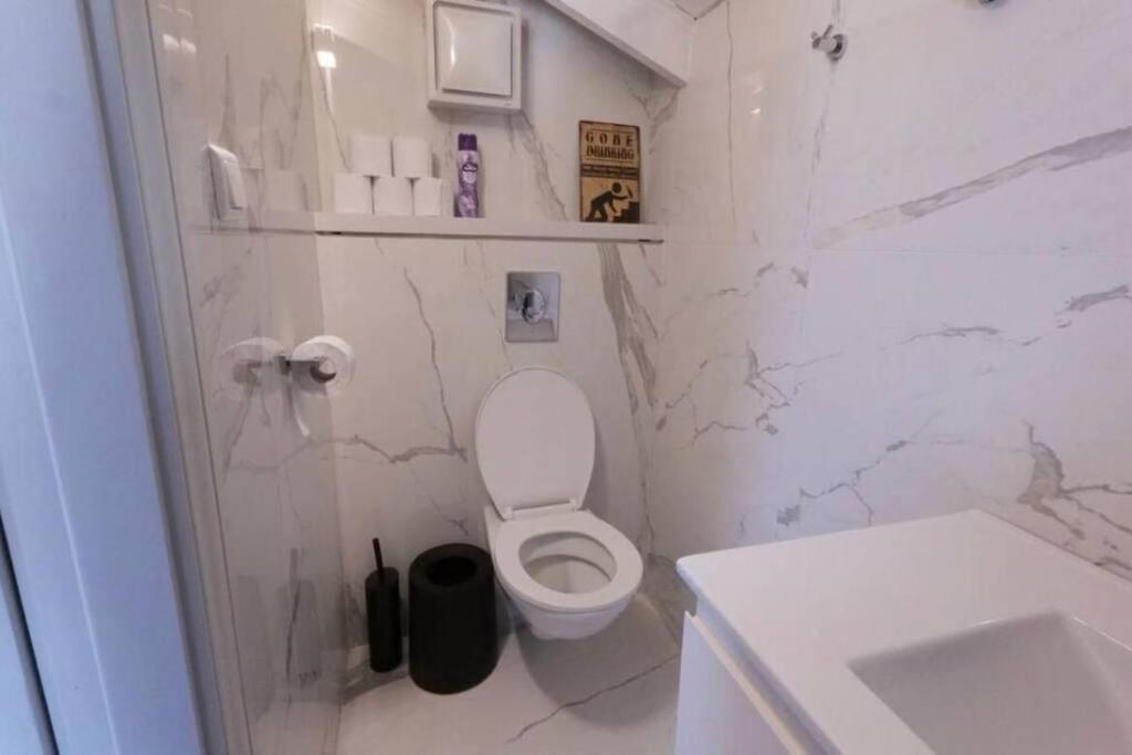 Baño blanco con aseo y lavamanos en דירת מדהימה נווה צדק 2, en Tel Aviv