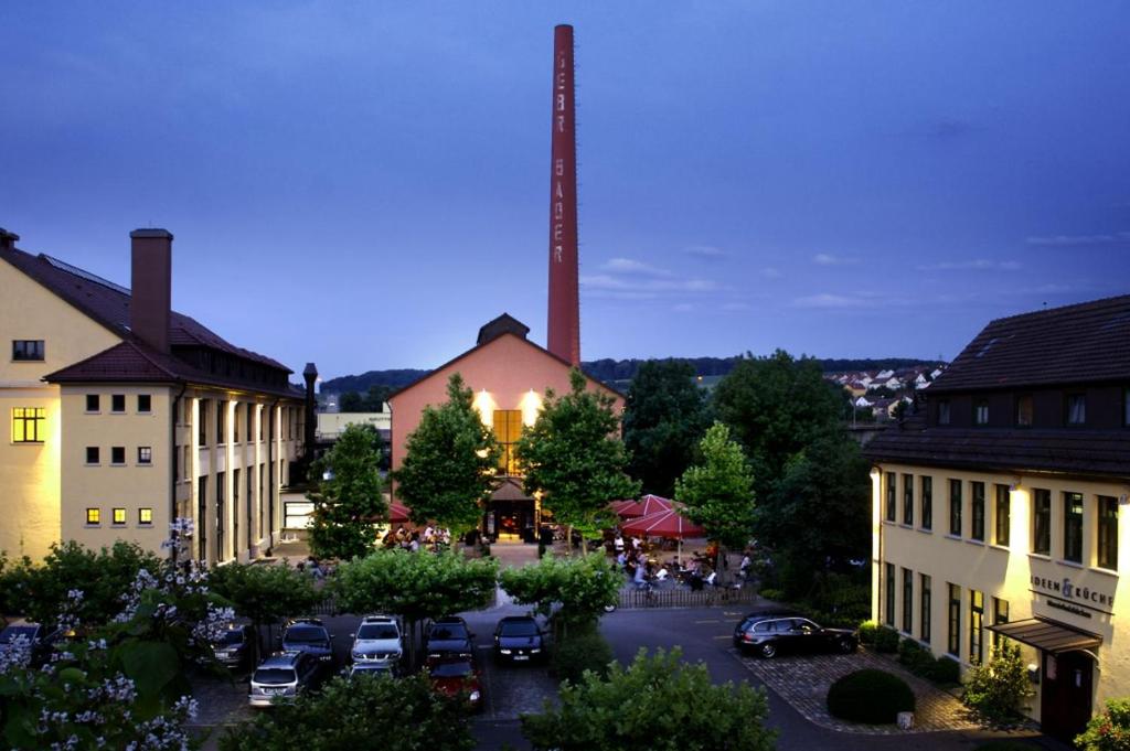 a view of a town with cars parked in a parking lot at Gerber Park Hotel in Uhingen