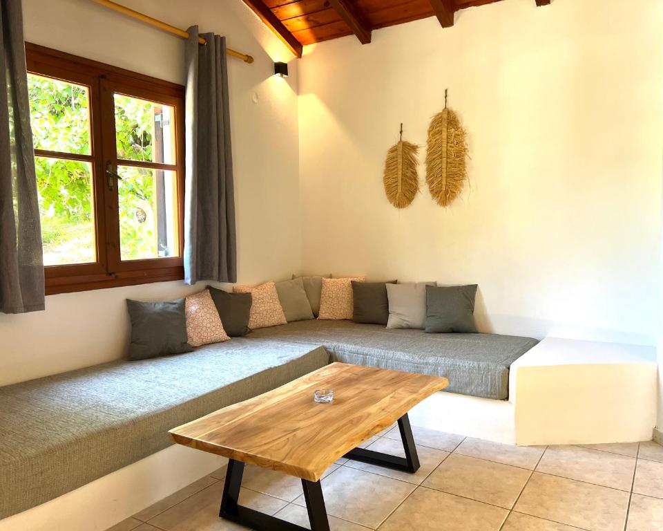 a living room with a couch and a table at Panos Villas in Koukounaries