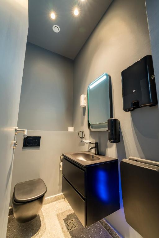 a bathroom with a sink and a toilet and a mirror at ARCA Resort 