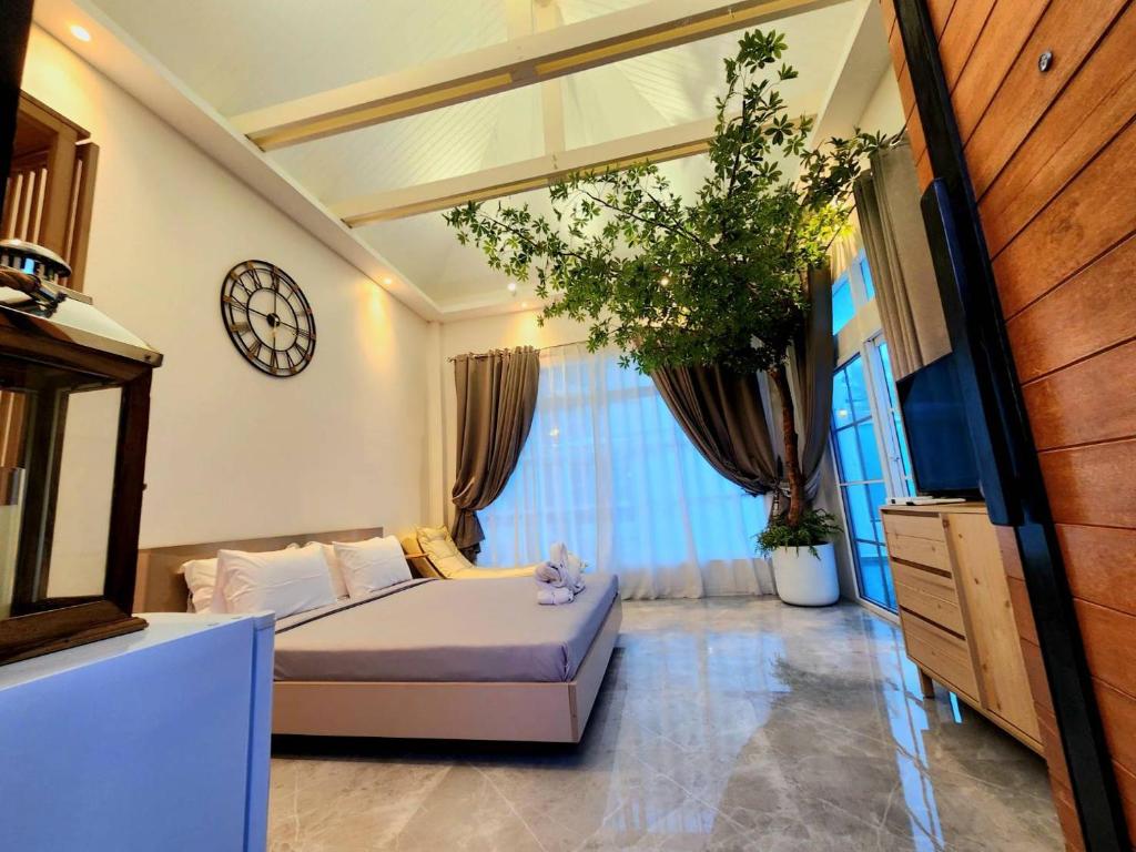 a bedroom with a bed and a dresser and a mirror at Skeyndor Health & Resort in Na Jomtien