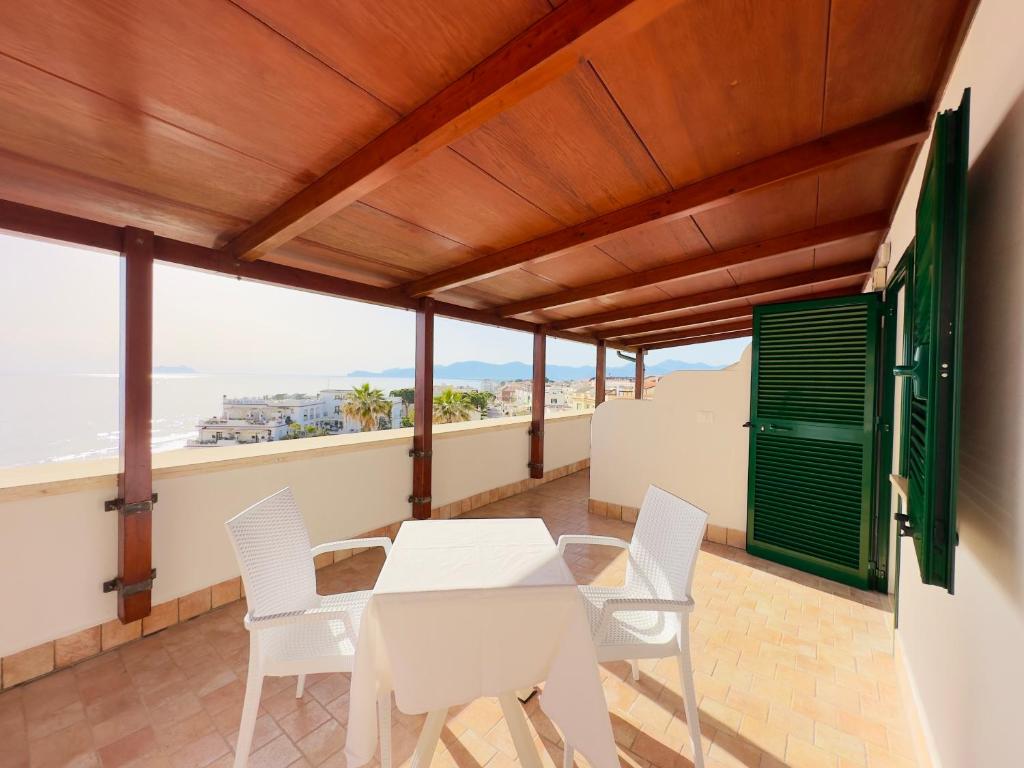 a balcony with a table and chairs and the ocean at Hotel Marconi in Sperlonga