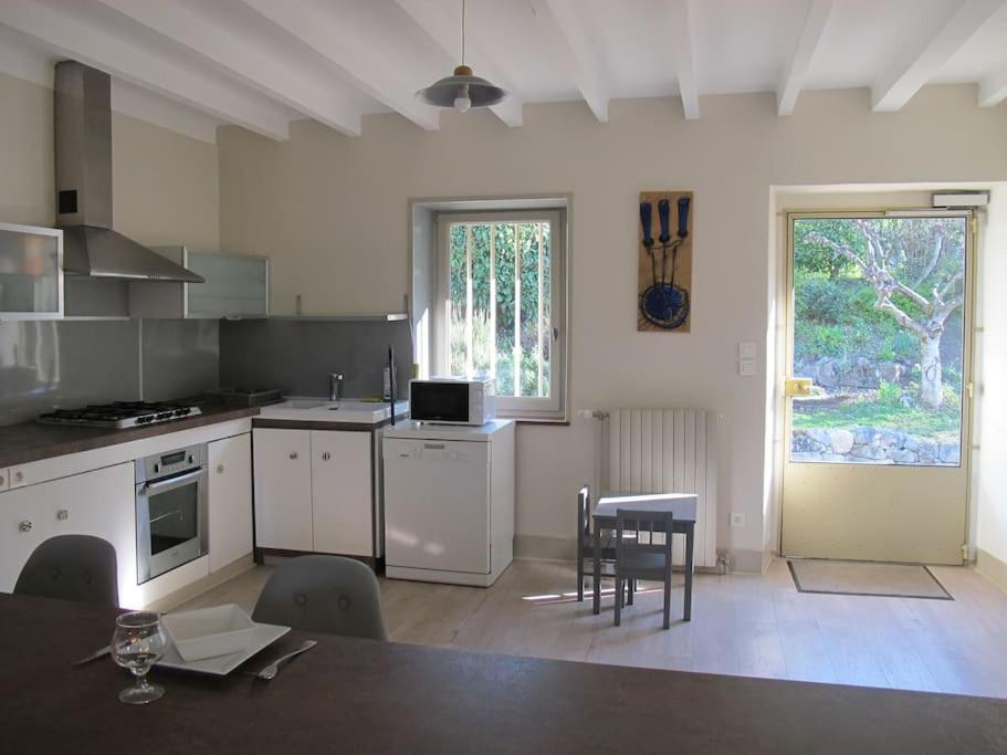 une cuisine avec une table et des chaises dans une pièce dans l'établissement La Cuesta, à Saint-Pierre-de-Curtille