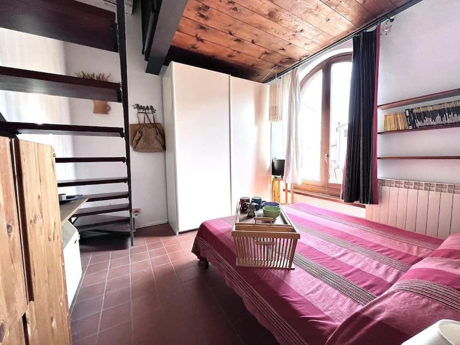 a room with a bed and a staircase in it at Casa Silvia in Lucca
