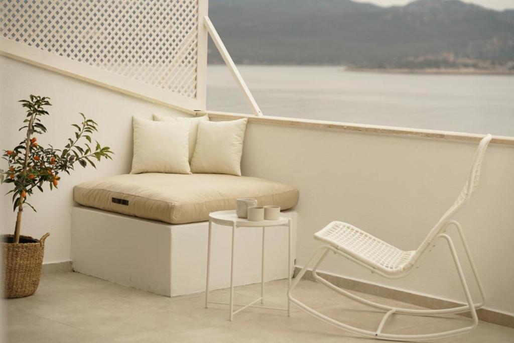 a chair and a table on a balcony at Blue Island Luxury Hotel Adults Only in Kaş