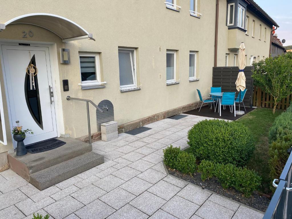 a house with a white door and a patio at Rhönluft 1 in Wildflecken