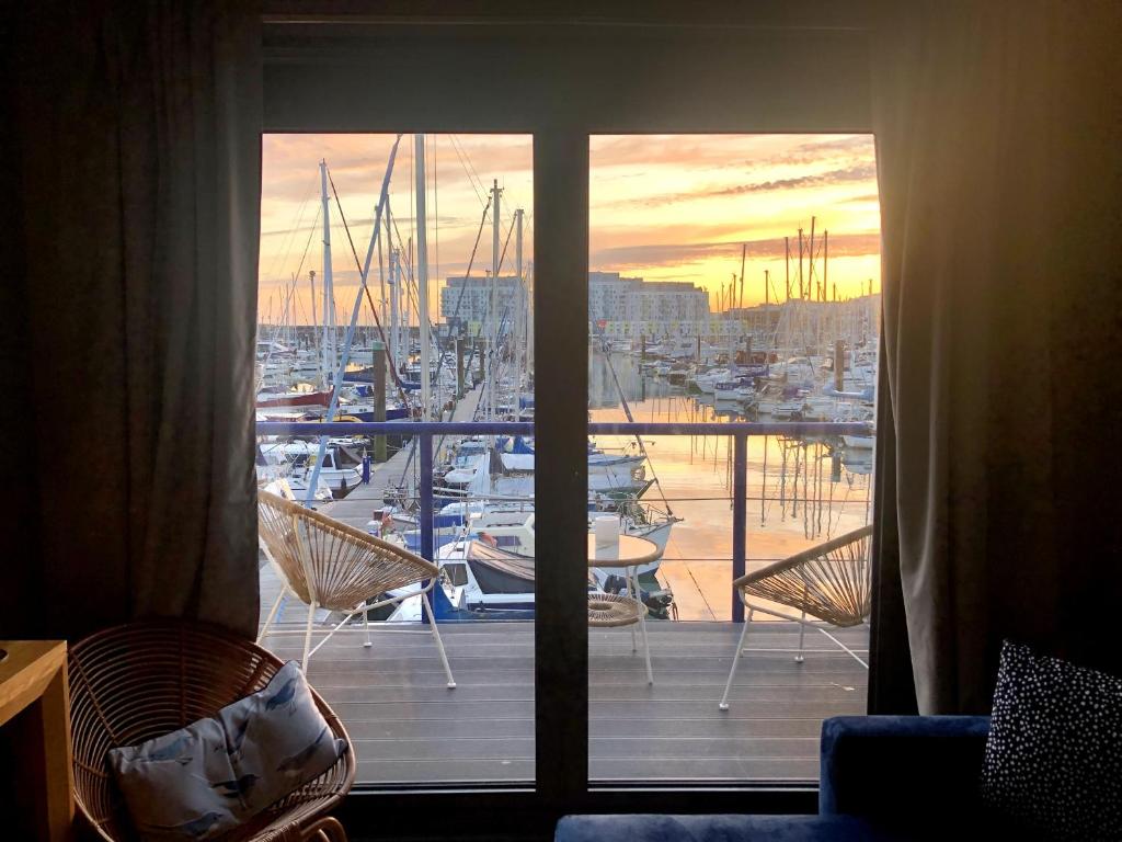 a view of a marina from a room with a window at Brighton Water Cabin - a unique floating holiday home in Brighton & Hove