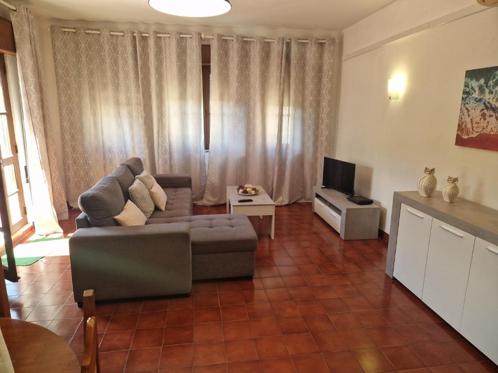 a living room with a couch and a television at T2 Alvor Terrace in Alvor