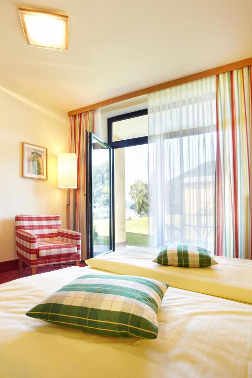 Postel nebo postele na pokoji v ubytování Riverresort Donauschlinge