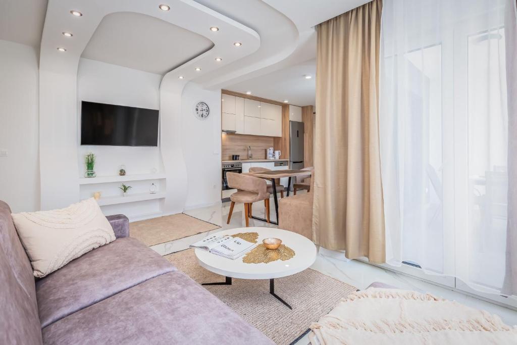 a living room with a couch and a table at Delux apartments Selina in Baška Voda