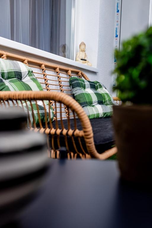 a wicker basket with pillows in front of a mirror at Lady-s in Cluj-Napoca