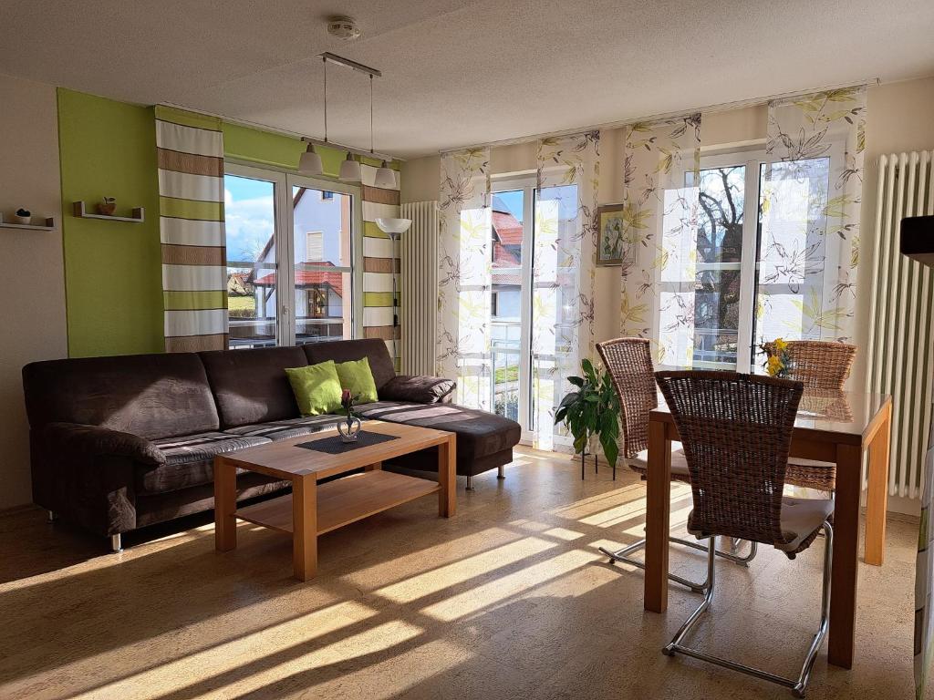 a living room with a couch and a table at Ferienwohnung Sauer in Pfofeld