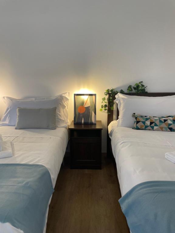 two beds sitting next to each other in a room at Bnbook Trilo Buonarroti Pero in Pero
