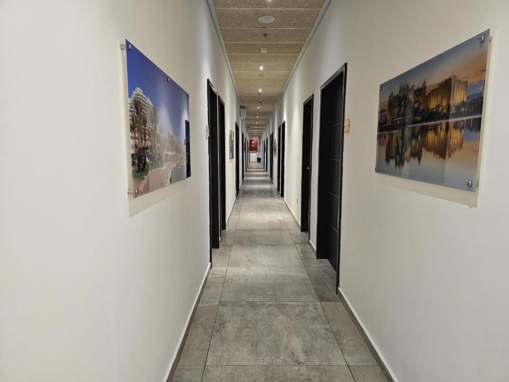 a hallway with paintings on the walls of a building at Sun Sea Center in Eilat