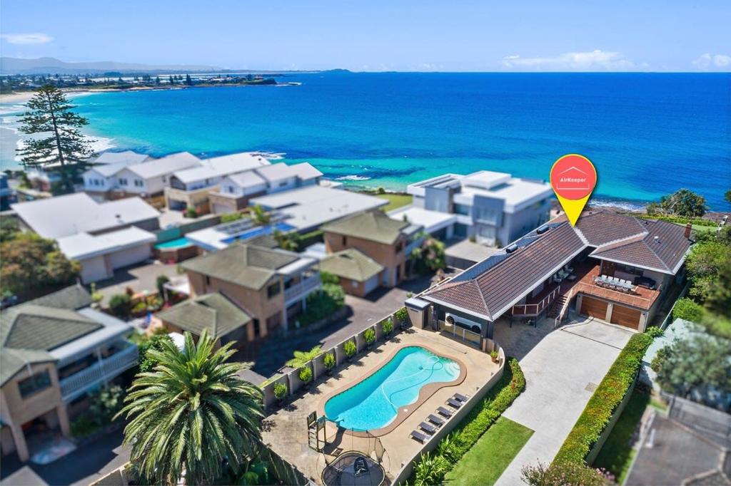 an aerial view of a house with a swimming pool at WATERFRONT HOME WITH POOL / SHELLHARBOUR in Shellharbour