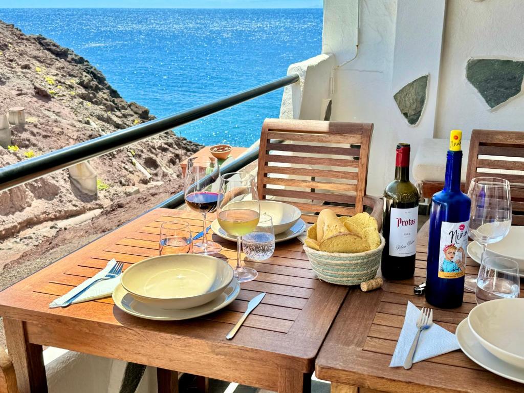 a table with plates and wine glasses on a balcony at La Gloria del Norte in Las Palmas de Gran Canaria