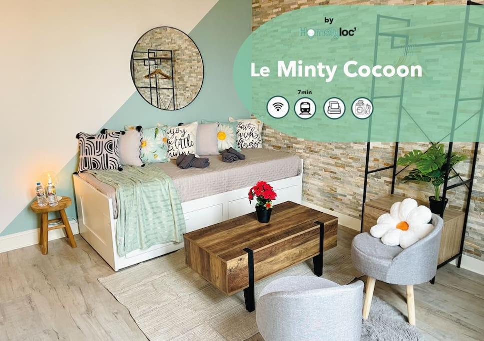 een woonkamer met een bed en een tafel bij Le MINTY Cocoon, bright & close to Paris in Maisons-Laffitte
