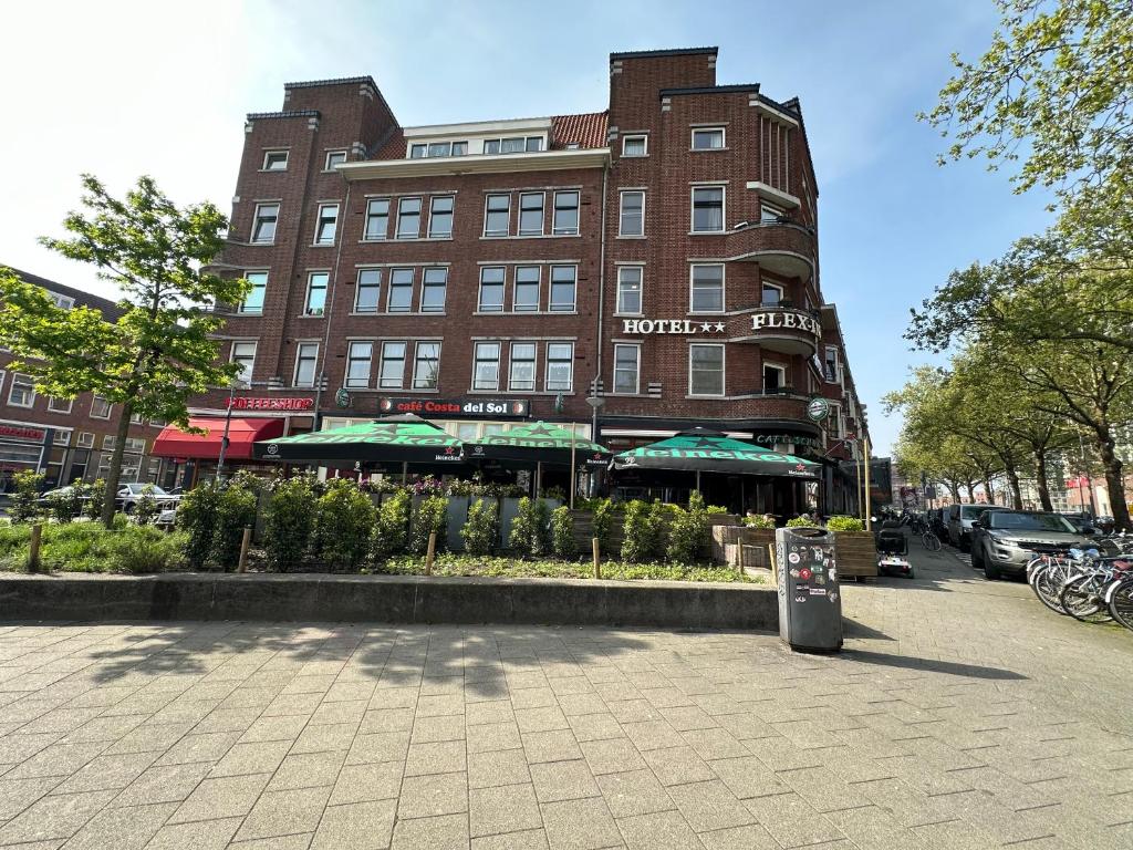 a large brick building in front of a building at Flex-Inn in Rotterdam