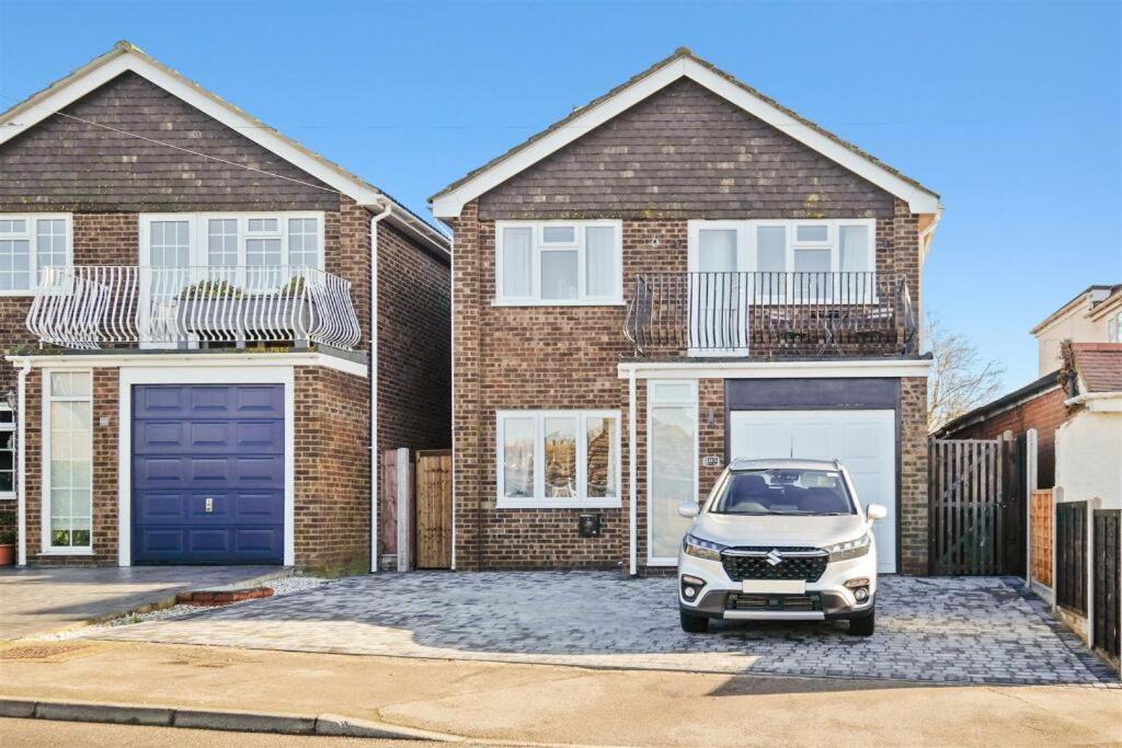 a car parked in front of a brick house at Stunning family home, walking distance to Herne Bay Beach! in Kent