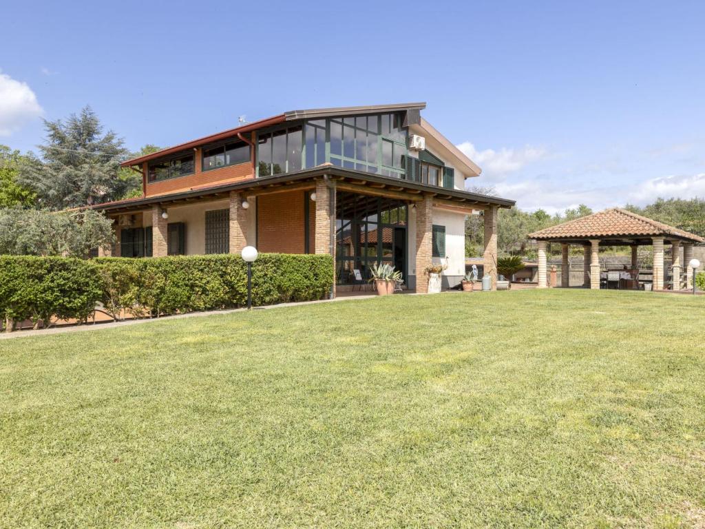 a house with a large lawn in front of it at Apartment Serena by Interhome in Piedimonte Etneo