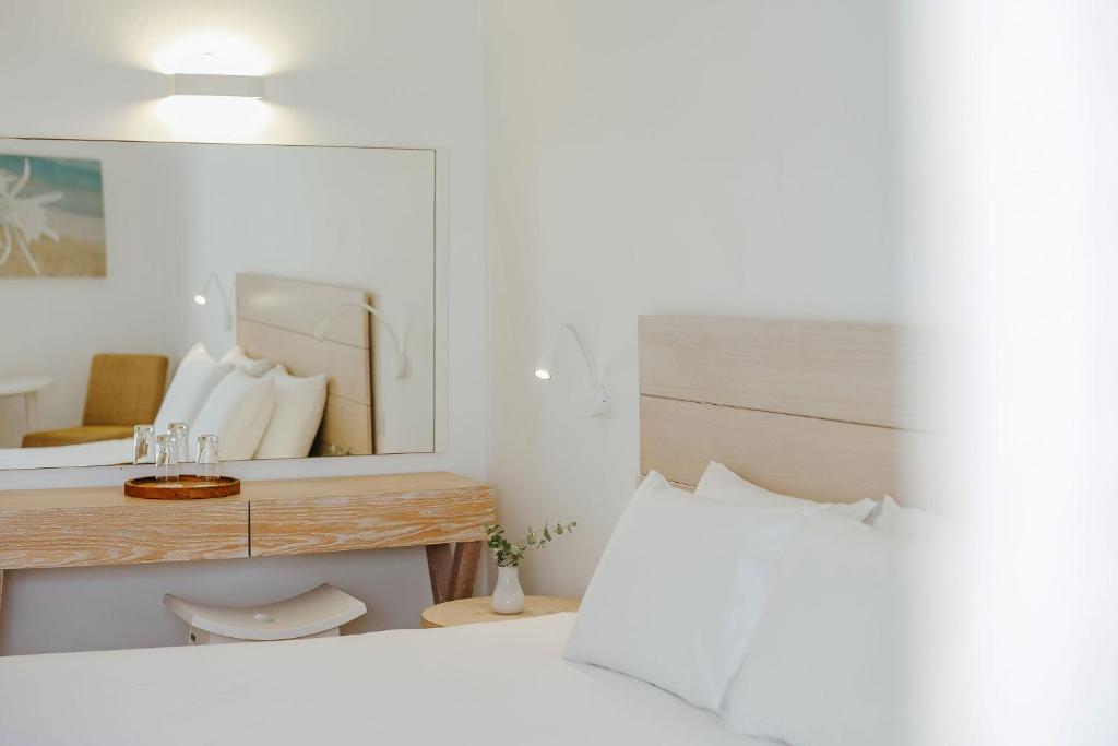 a bedroom with a large mirror and a bed at Nissi Park Hotel in Ayia Napa