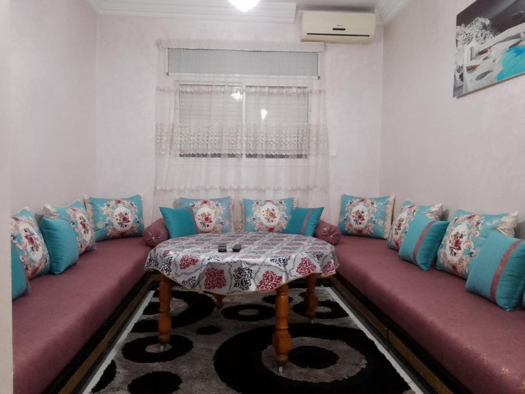 a living room with a couch and a table at Appartement de vacances in Agadir