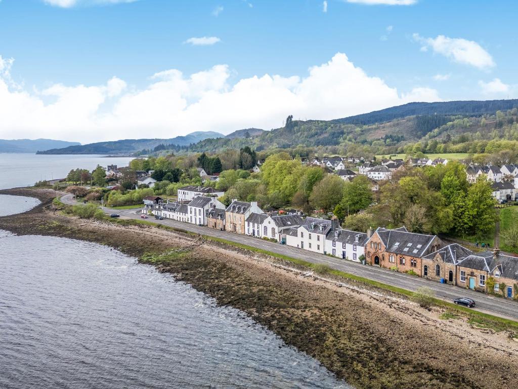 a town next to a body of water with houses at Newton Hall in Inveraray