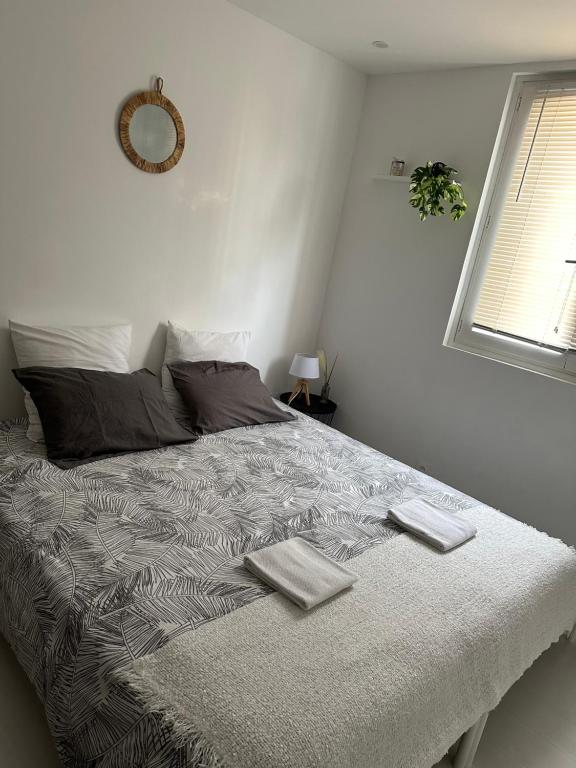 a bedroom with a bed with two towels on it at Privât Room In private security residence with free parking, 1 minute from tramway, 9 minutes from de center, accessible all transports in Nice