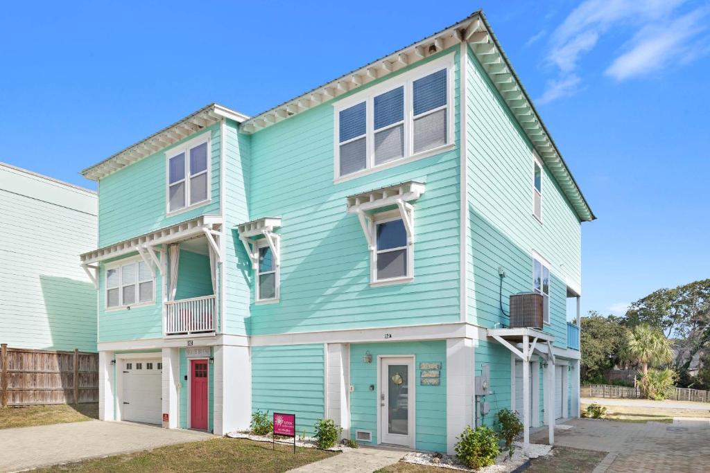 a blue house with white trim at Peach Coral in Tybee Island