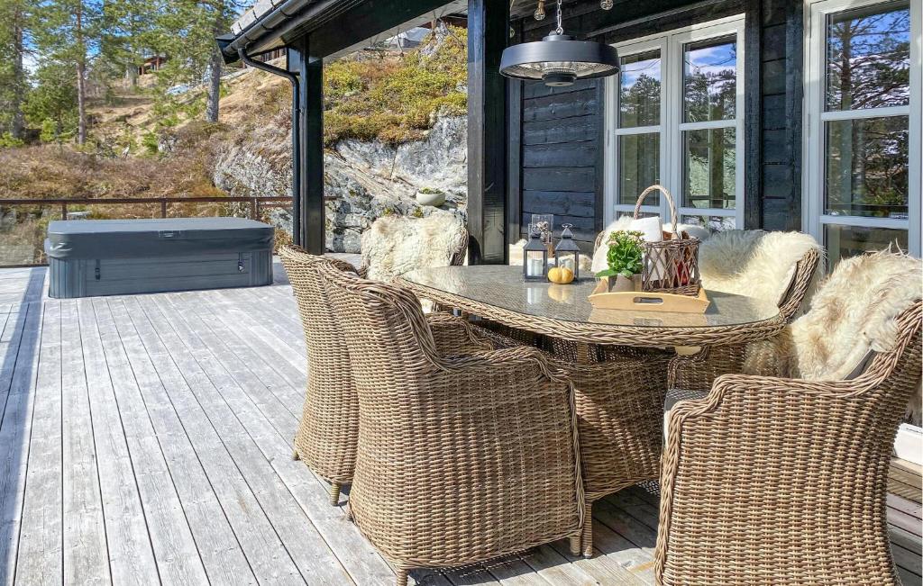 a patio with a table and chairs on a deck at Lovely Home In Stryn With House A Panoramic View in Stryn