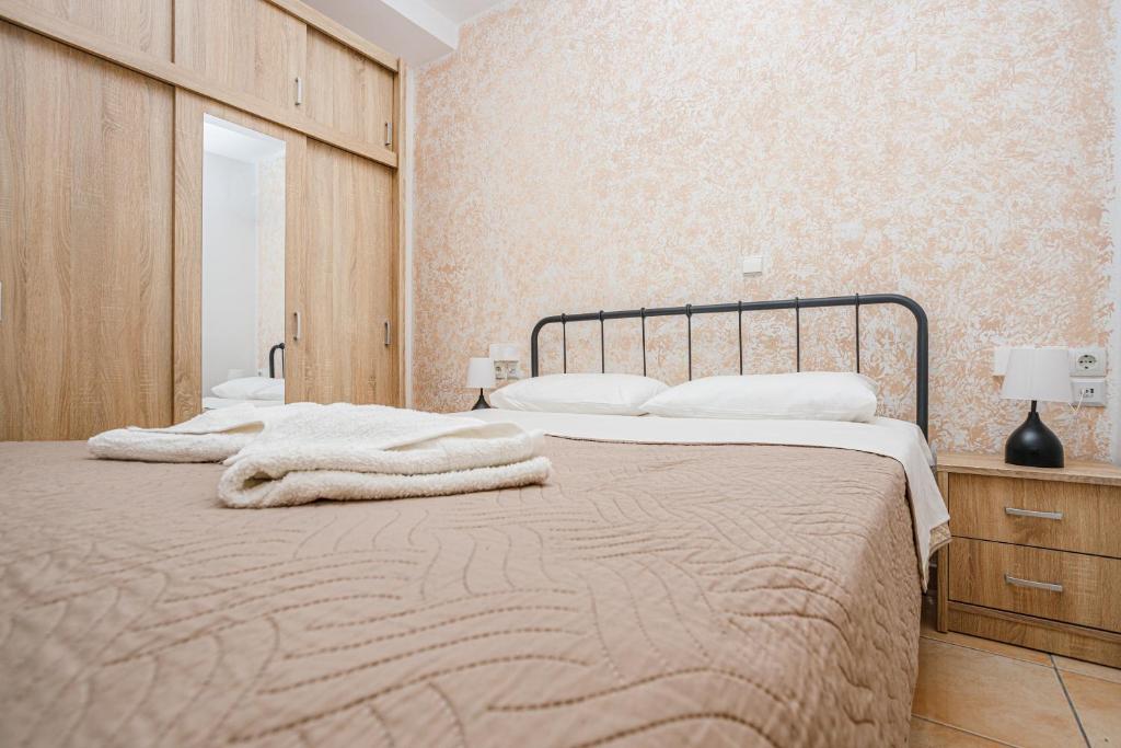 a bedroom with two beds with towels on them at Sunrise Apartment in Heraklio Town