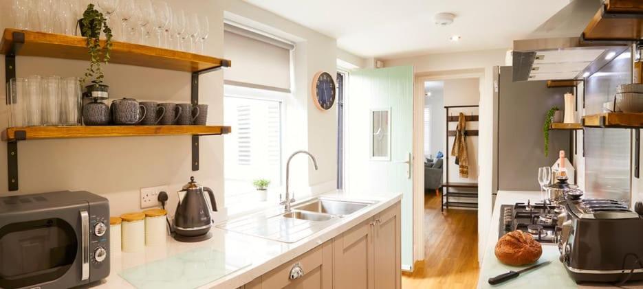 a kitchen with a sink and a counter top at Sandholme Cottage - Central location great for families in Filey