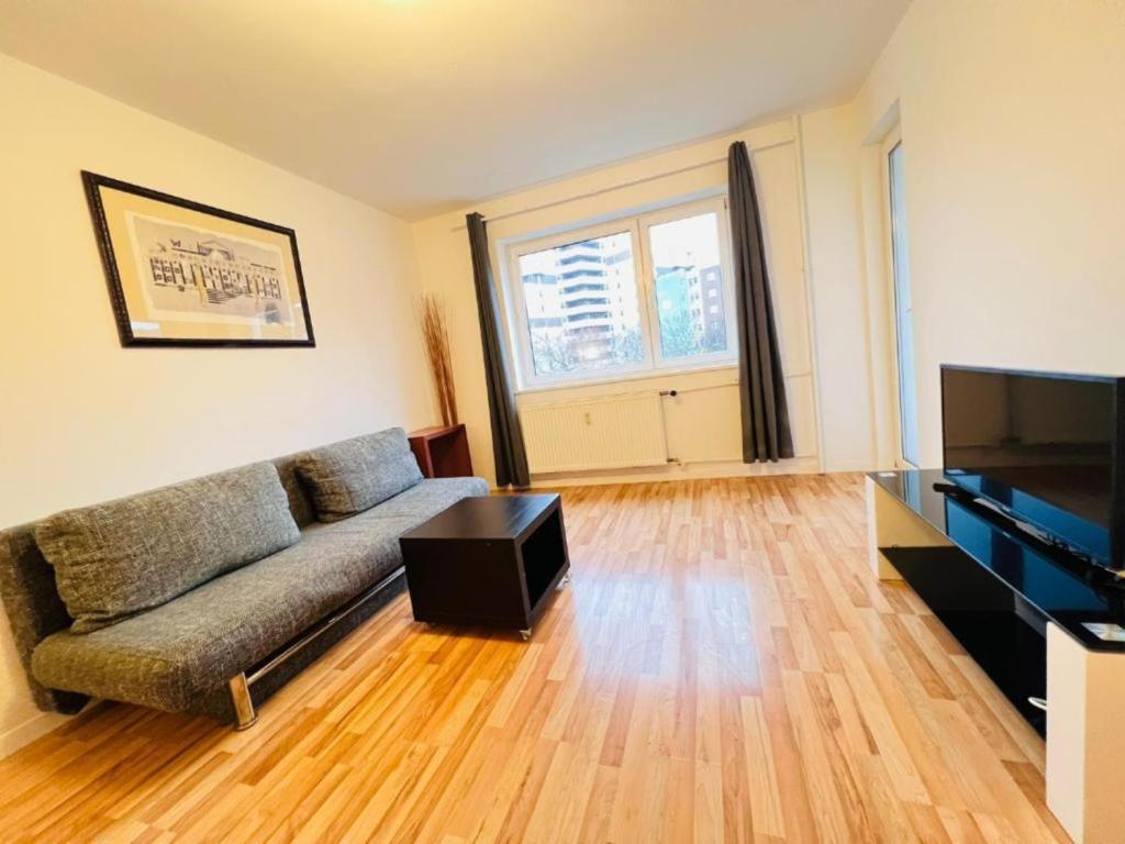 a living room with a couch and a flat screen tv at Central City West 3 in Berlin