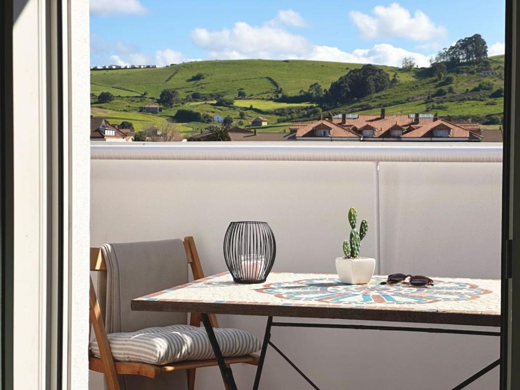 a table and chairs on a balcony with a view at Betula Pendula - 12601 in Ajo