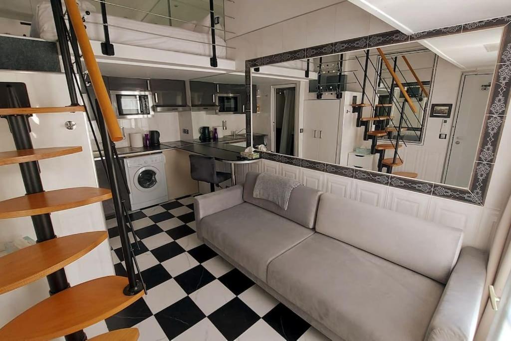 a living room with a couch and a checkered floor at Duplex Nôtre-Dame de Paris in Paris