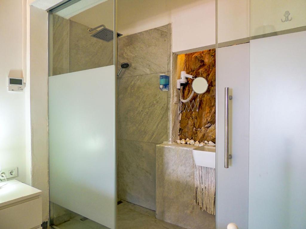 a shower with a glass door in a bathroom at Oza Boutique hotel in Gümüşlük