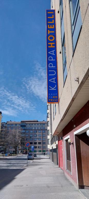 a blue sign on the side of a building at Kauppahotelli in Lahti