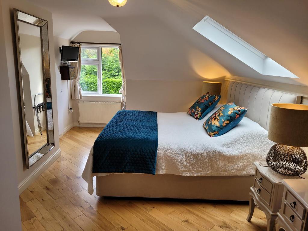 a bedroom with a bed and a large window at Rockcrest House in Kenmare