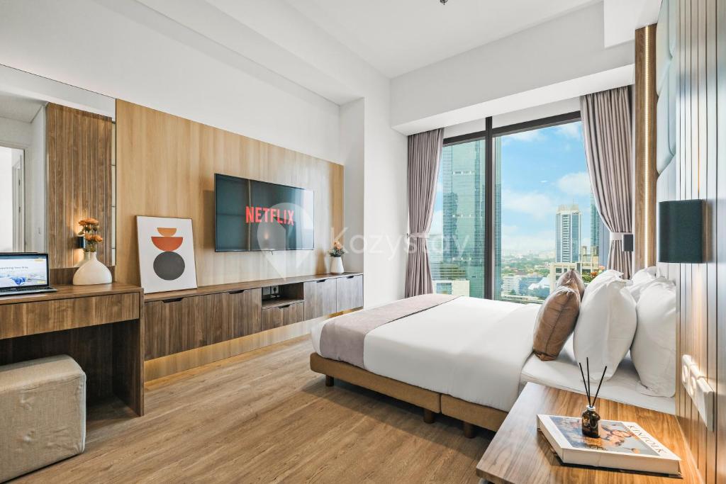a hotel room with a bed and a large window at Rhone by Kozystay - Thamrin in Jakarta