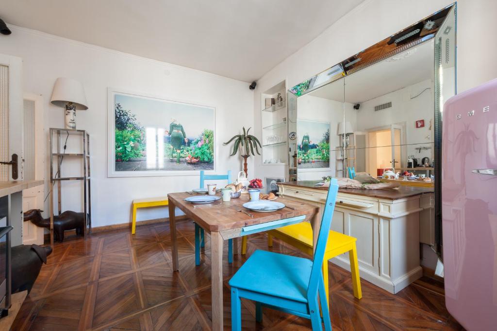 a kitchen with a wooden table and blue chairs at G House in Venice