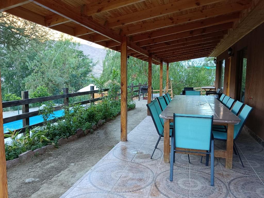 un tavolo e sedie in legno su un patio di Cabaña Cerro Tulahuén a Piedra Lisa