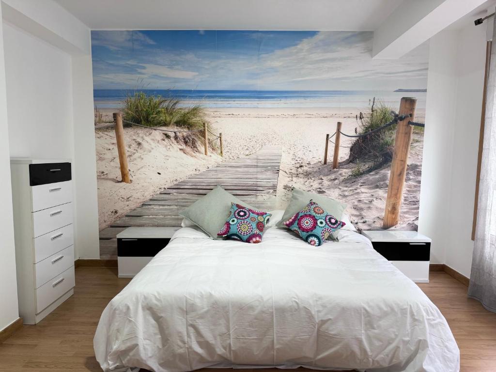 a bedroom with a bed and a mural of a beach at ¡VIVA VIGO! Tu escapada perfecta in Vigo